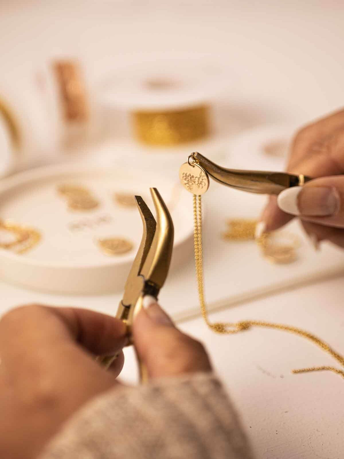 handcrafted necklace an Australian birth flower pendant being assembled with pliers 